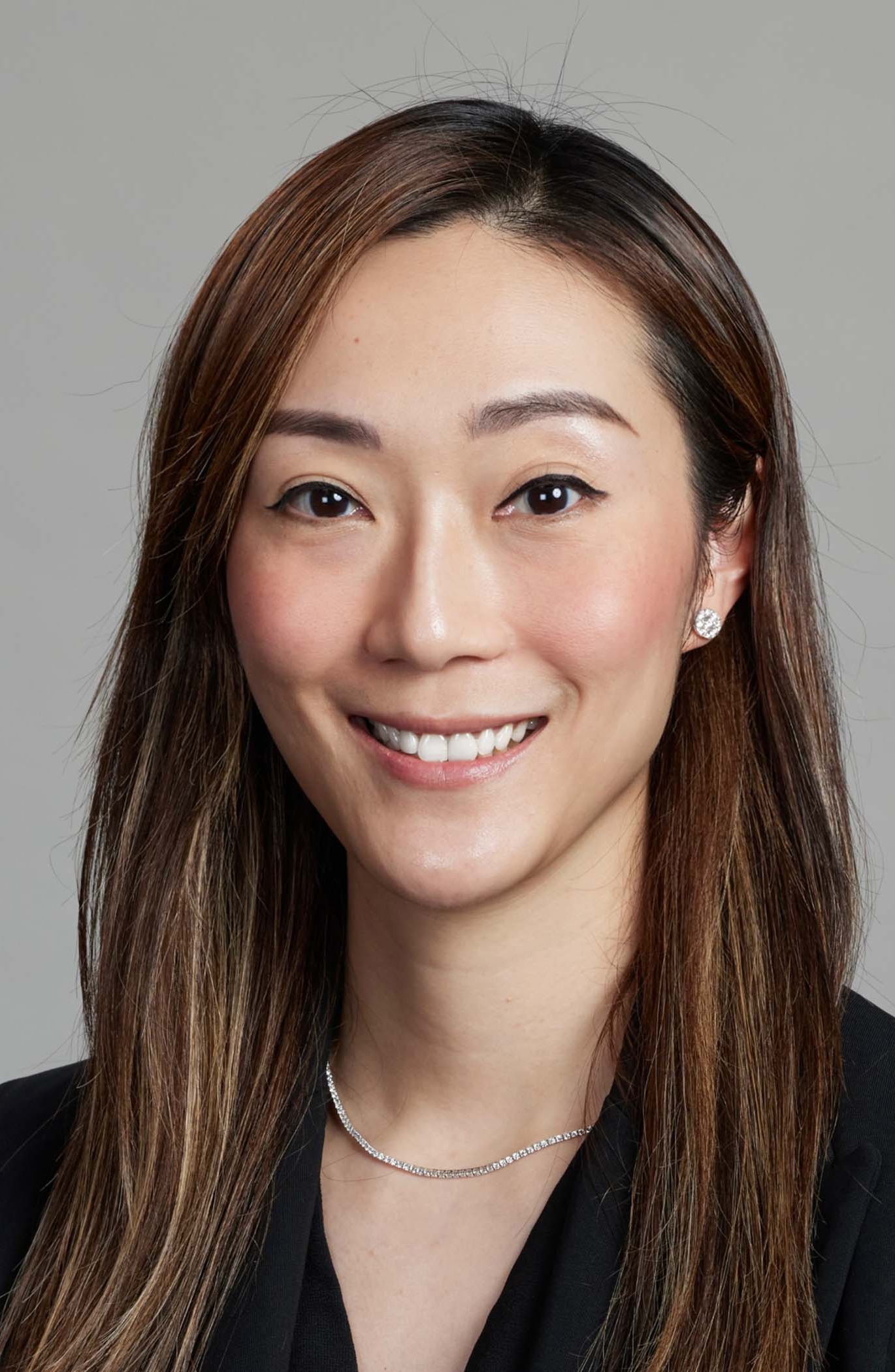 A professional headshot of Lily Chan