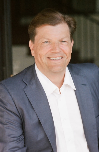 A professional headshot of John Mallory