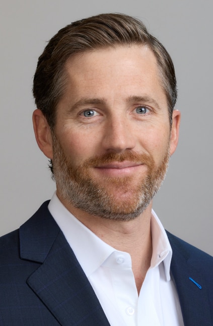 A professional headshot of Chris Gleason