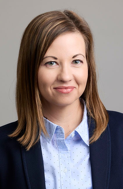 A professional headshot of Laura Carroll