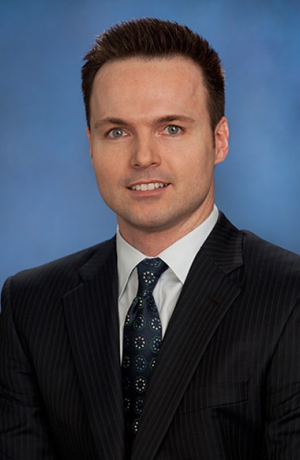 A professional headshot of Brett Nelson